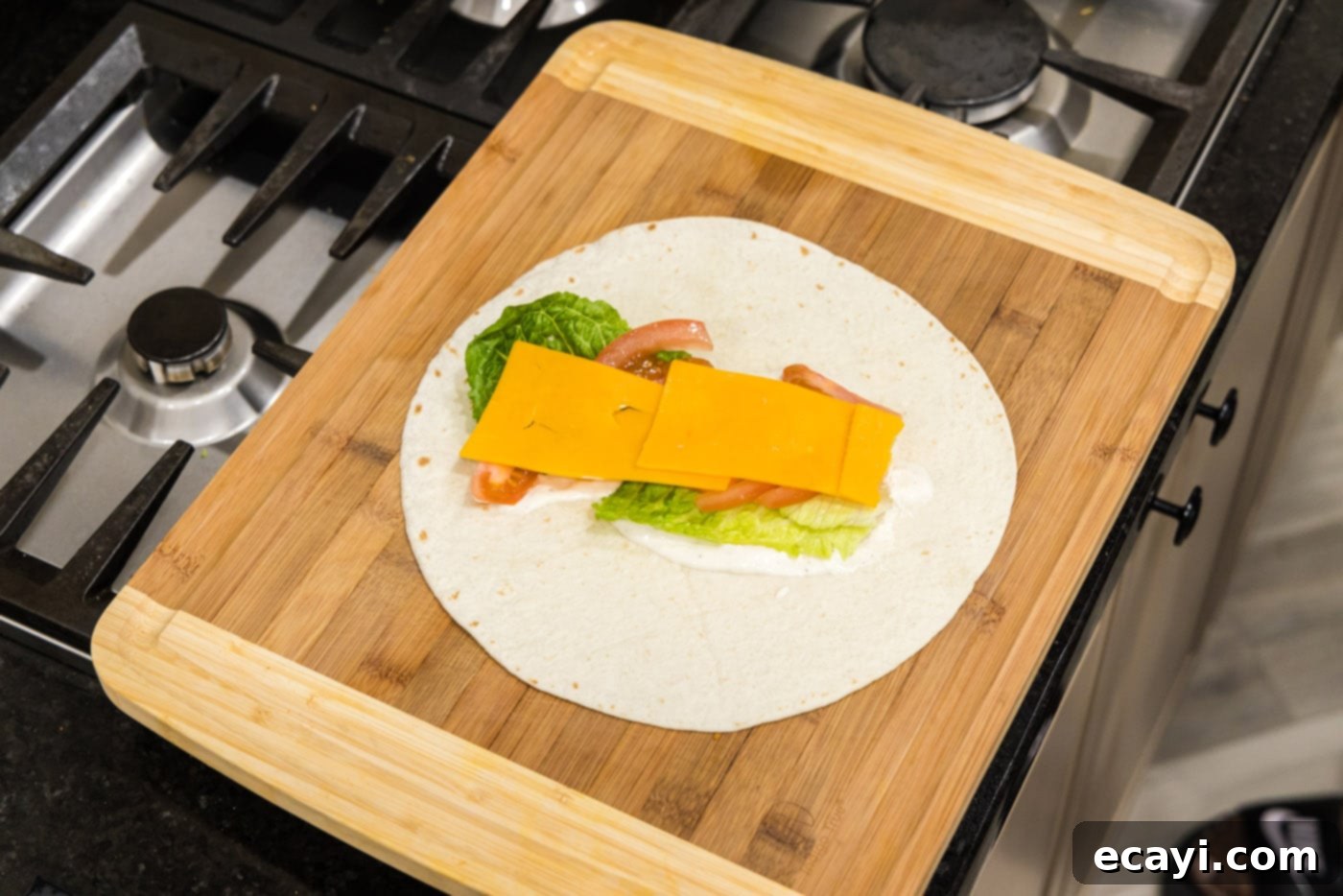 Signature Chicken Bacon Ranch Wrap 8 sliced cheese on top of lettuce, ranch, and tomato tortilla