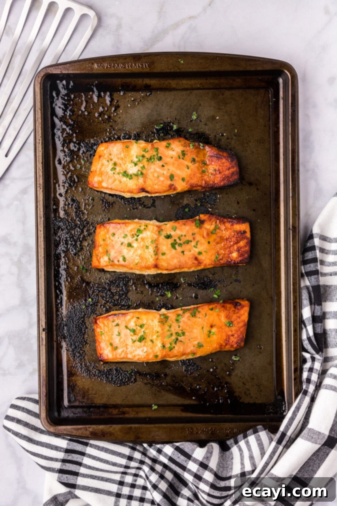 Caramelized Salmon 3 Three pieces of Brown Sugar Salmon on a sheet pan, ready to be served.
