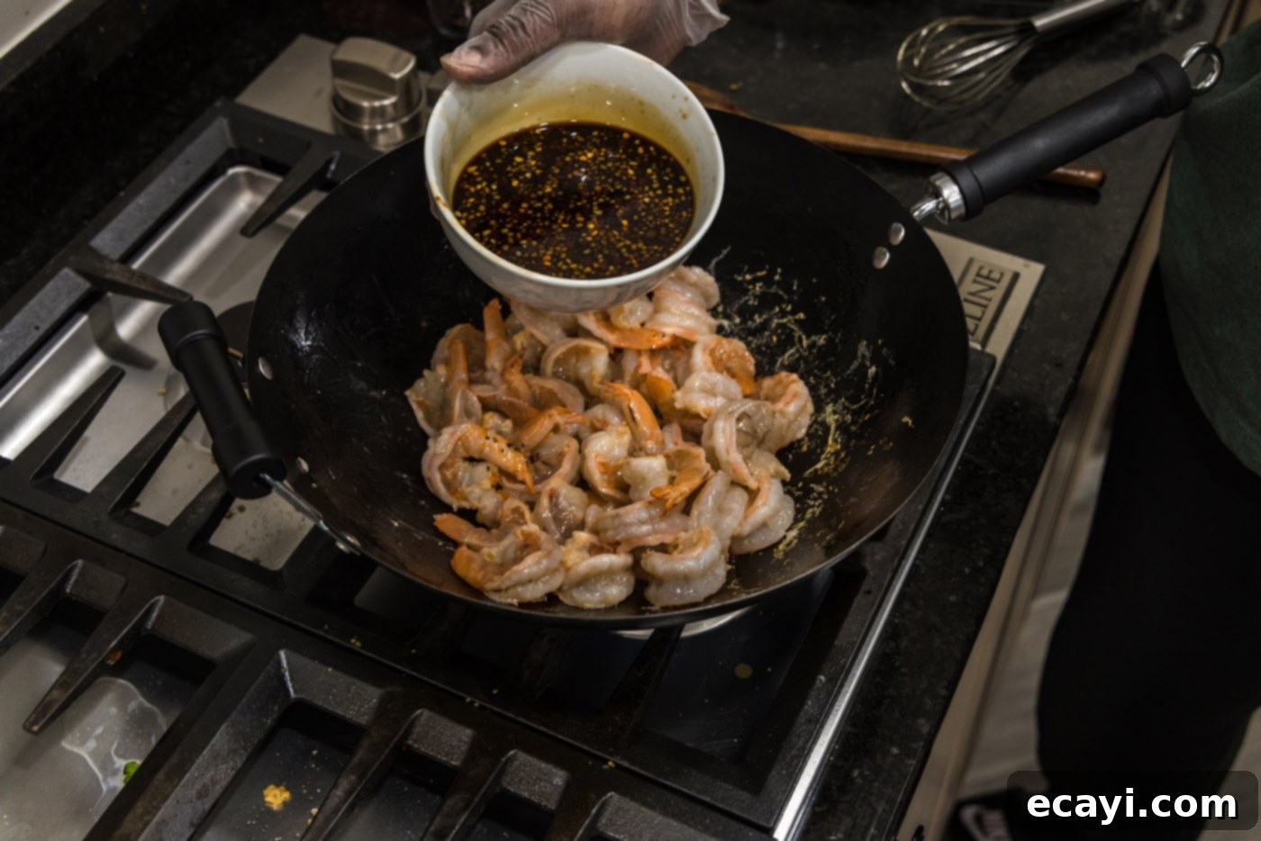 Fiery Hunan Shrimp 6 Adding the freshly mixed Hunan sauce to the stir-fried shrimp in the wok
