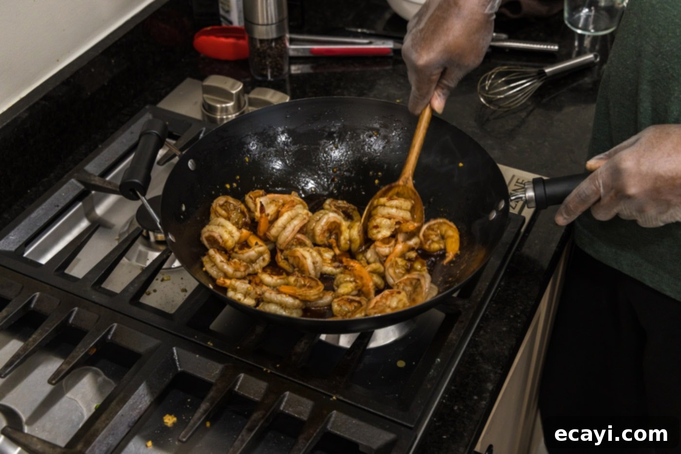 Fiery Hunan Shrimp 7 Tossing the shrimp thoroughly in the wok to ensure they are fully coated in the spicy Hunan sauce