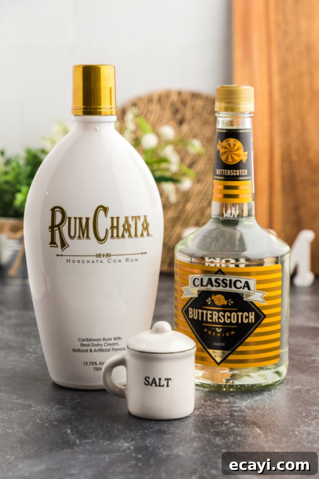 Salted Caramel Nut Blast 4 Ingredients for Salted Nut Roll Shot laid out: RumChata, Butterscotch Schnapps, and a small plate of salt