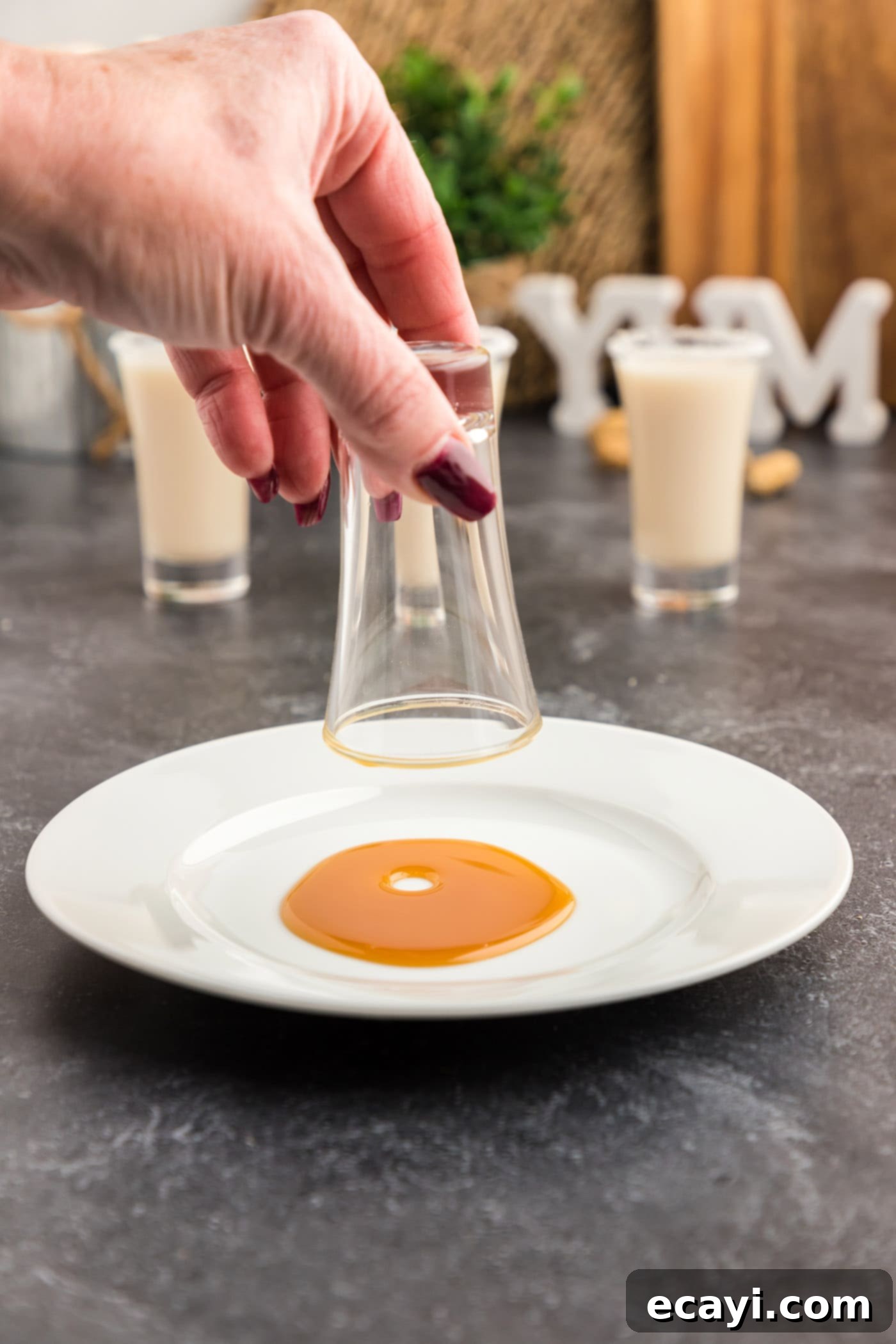 Salted Caramel Nut Blast 6 Dipping shot glass rim into caramel syrup before salting