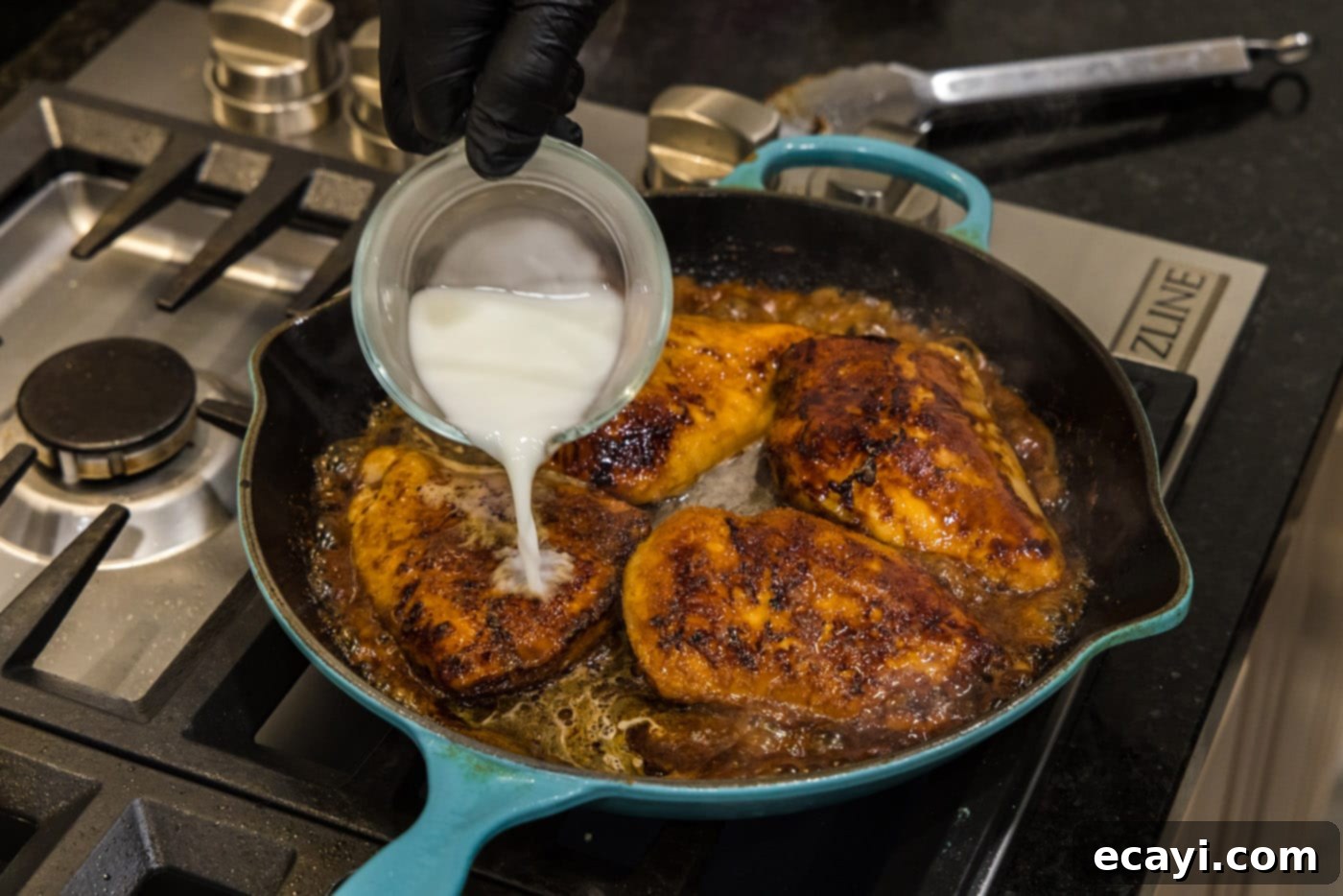Sticky Honey Garlic Chicken 10 adding cornstarch slurry to skillet with chicken and sauce