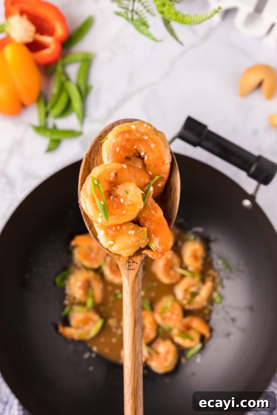 Teriyaki Shrimp 2 Spoonful of Teriyaki Shrimp held above a wok