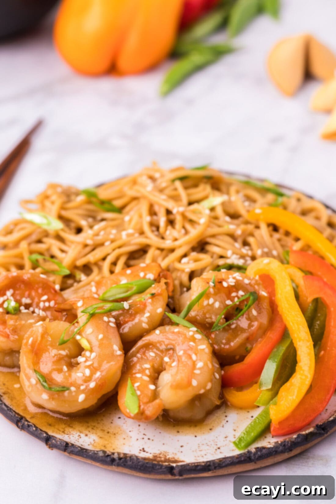 Teriyaki Shrimp 3 Teriyaki Shrimp on a plate with teriyaki noodles and sliced peppers