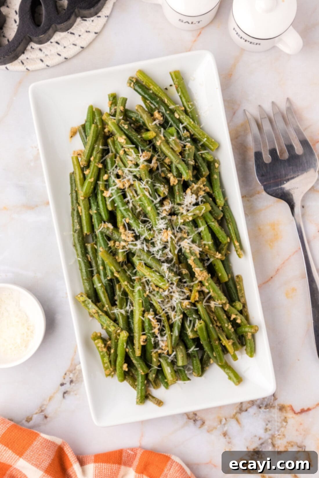 Garlic-Kissed Green Beans 3 Garlic Green Beans on a platter garnished with parmesan cheese, ready to be served as a delicious side dish