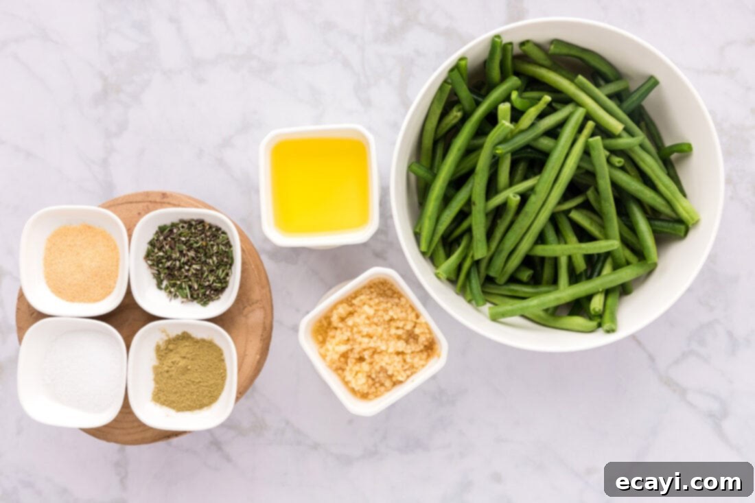 Garlic-Kissed Green Beans 4 Fresh green beans, minced garlic, olive oil, rosemary, sage, garlic powder, and salt laid out as ingredients for the recipe