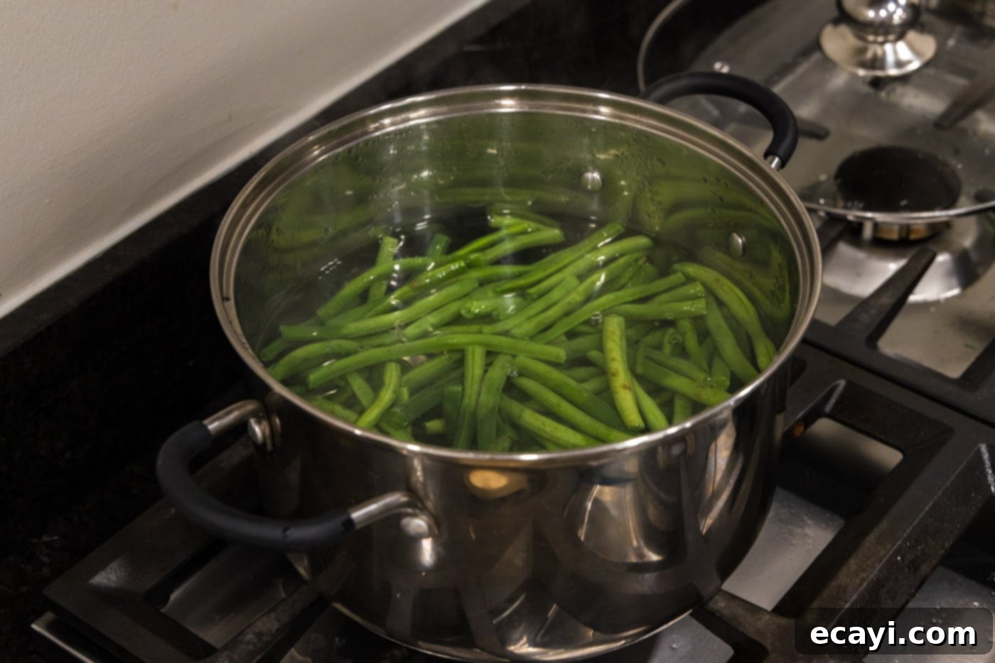 Garlic-Kissed Green Beans 5 boiling green beans in a pot of hot water for blanching