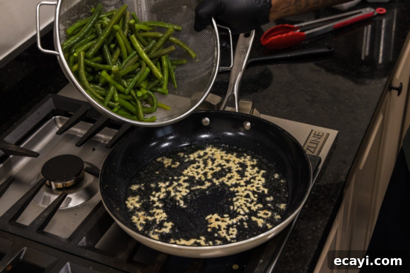 Garlic-Kissed Green Beans 6 adding green beans to a hot skillet with olive oil and minced garlic