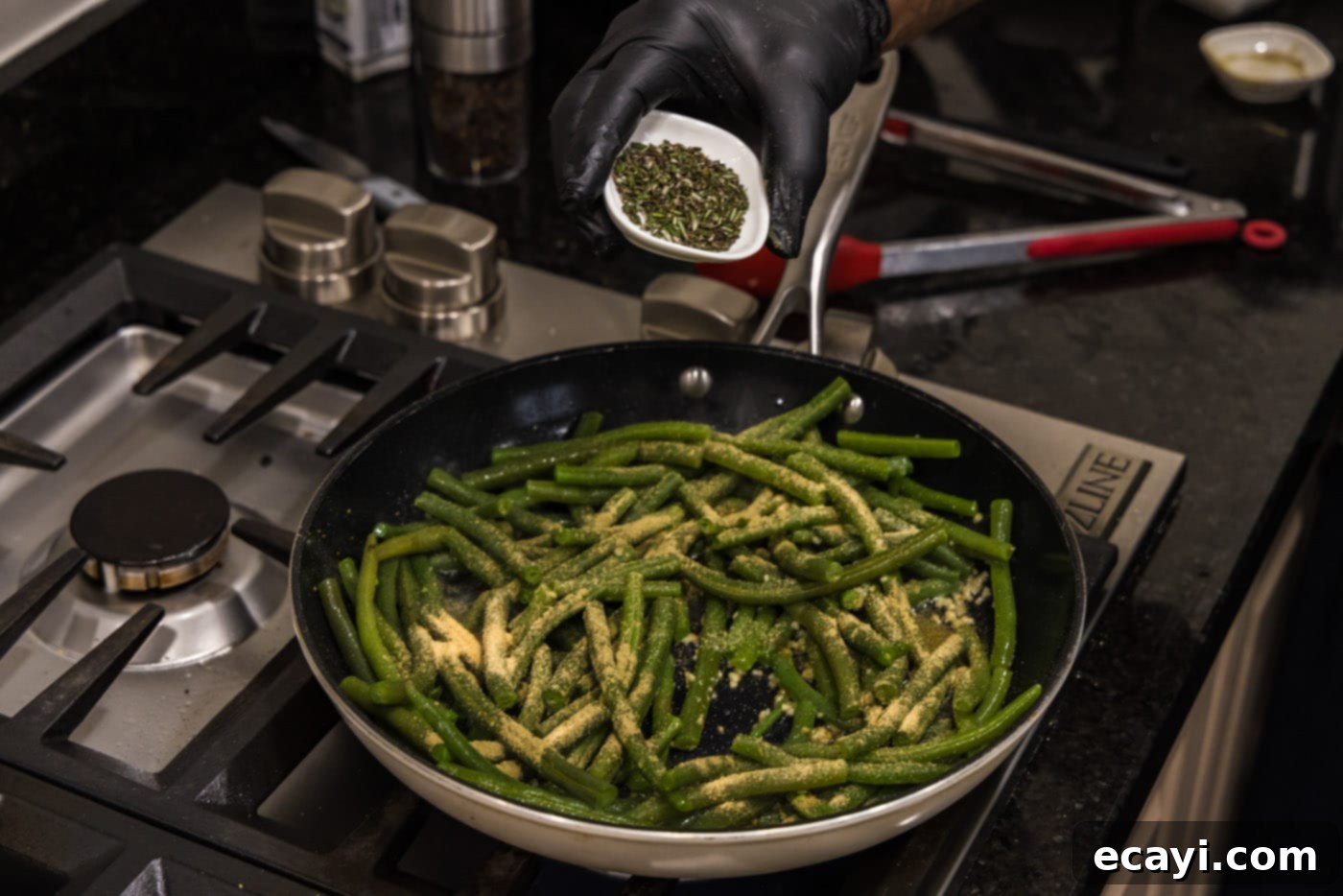 Garlic-Kissed Green Beans 7 adding fresh rosemary to a skillet with sautéing green beans