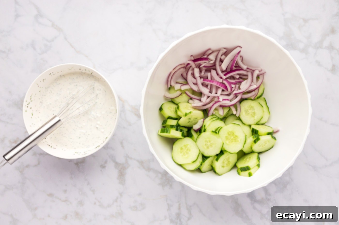 Cool and Creamy Cucumbers 5 red onion and cucumber in a mixing bowl along with creamy dressing on the side