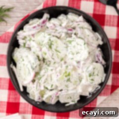 Cool and Creamy Cucumbers 7 Bowl of Creamy Cucumber Salad, garnished with fresh dill.