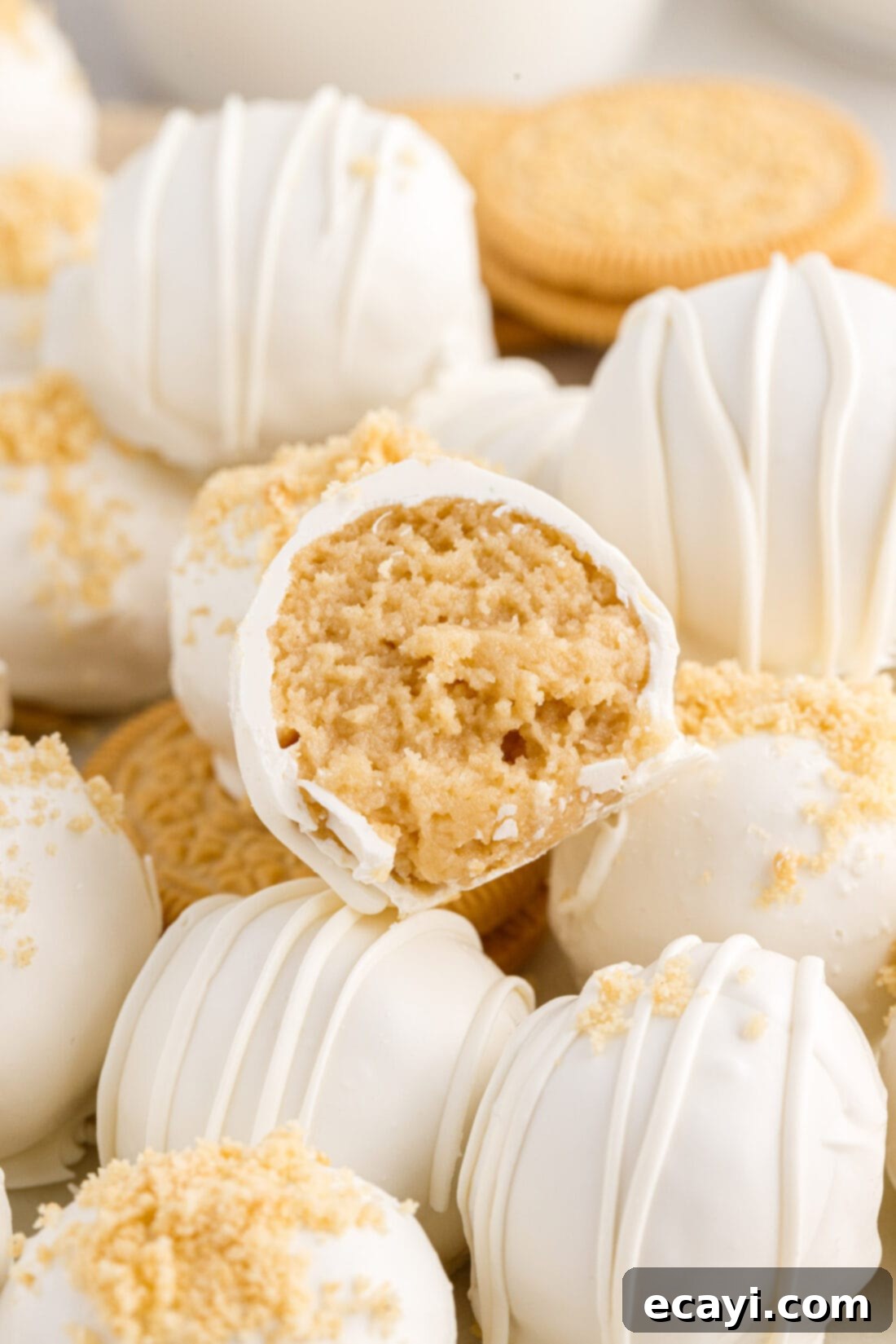 No-Bake Golden Oreo Bliss 2 Close up photo of a Golden Oreo Truffle with a bite taken out, revealing the creamy center.