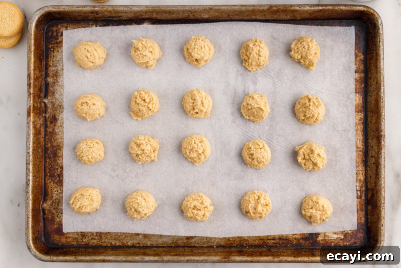 No-Bake Golden Oreo Bliss 11 Placing uniform balls of Golden Oreo dough onto a parchment-lined baking sheet.