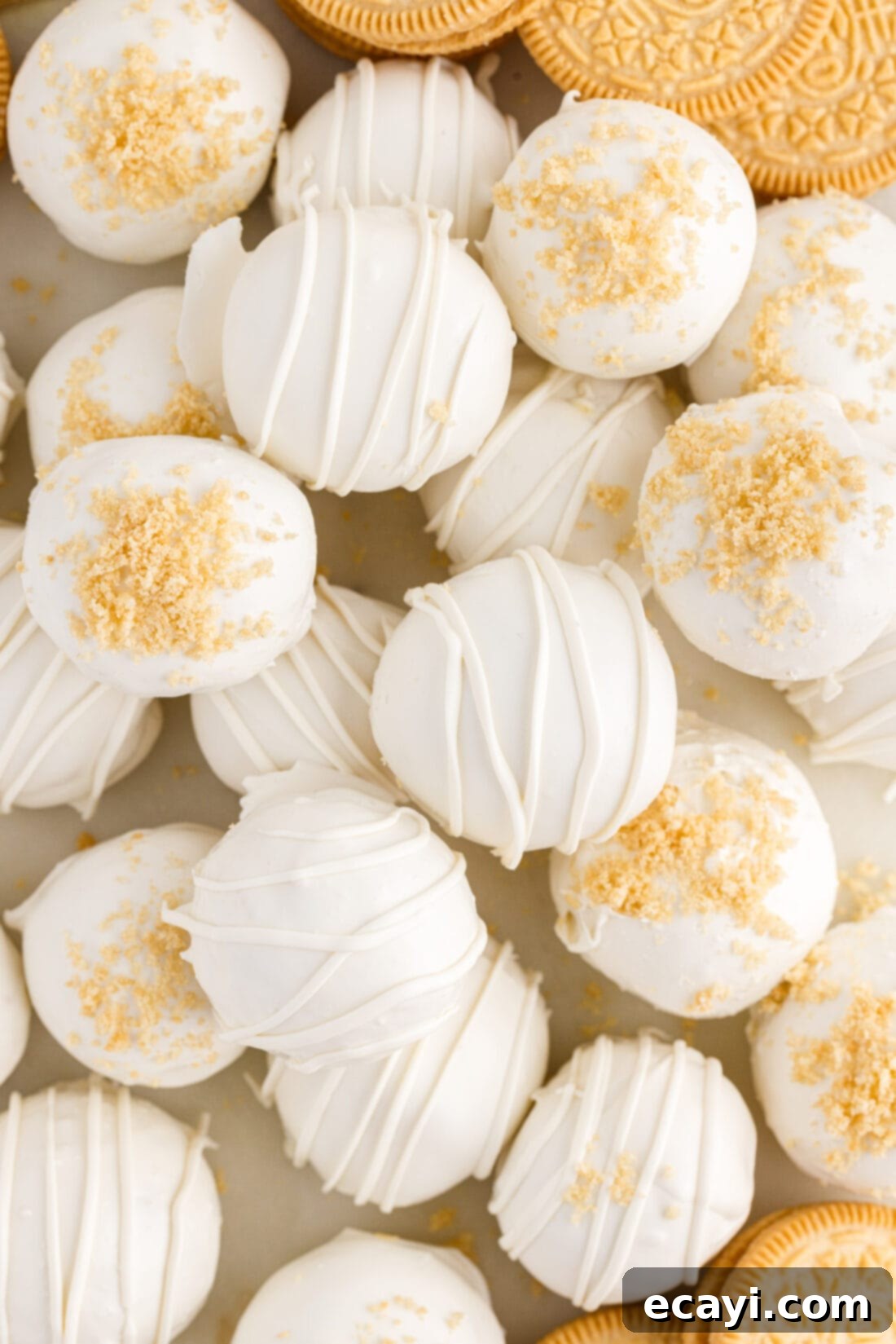 No-Bake Golden Oreo Bliss 17 An assortment of Golden Oreo Truffles, some plain, some with drizzles, and some with sprinkles.