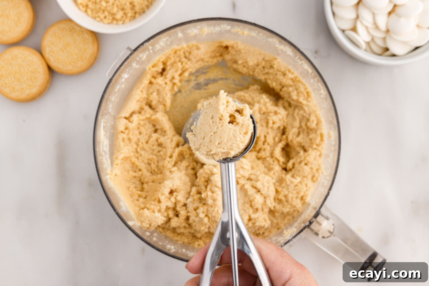 No-Bake Golden Oreo Bliss 10 Scooping the Golden Oreo truffle dough from the bowl.