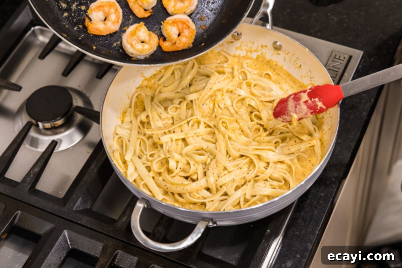 Shrimp Alfredo Bliss 13 Combining the perfectly cooked shrimp with the fettuccine and alfredo sauce for the final dish