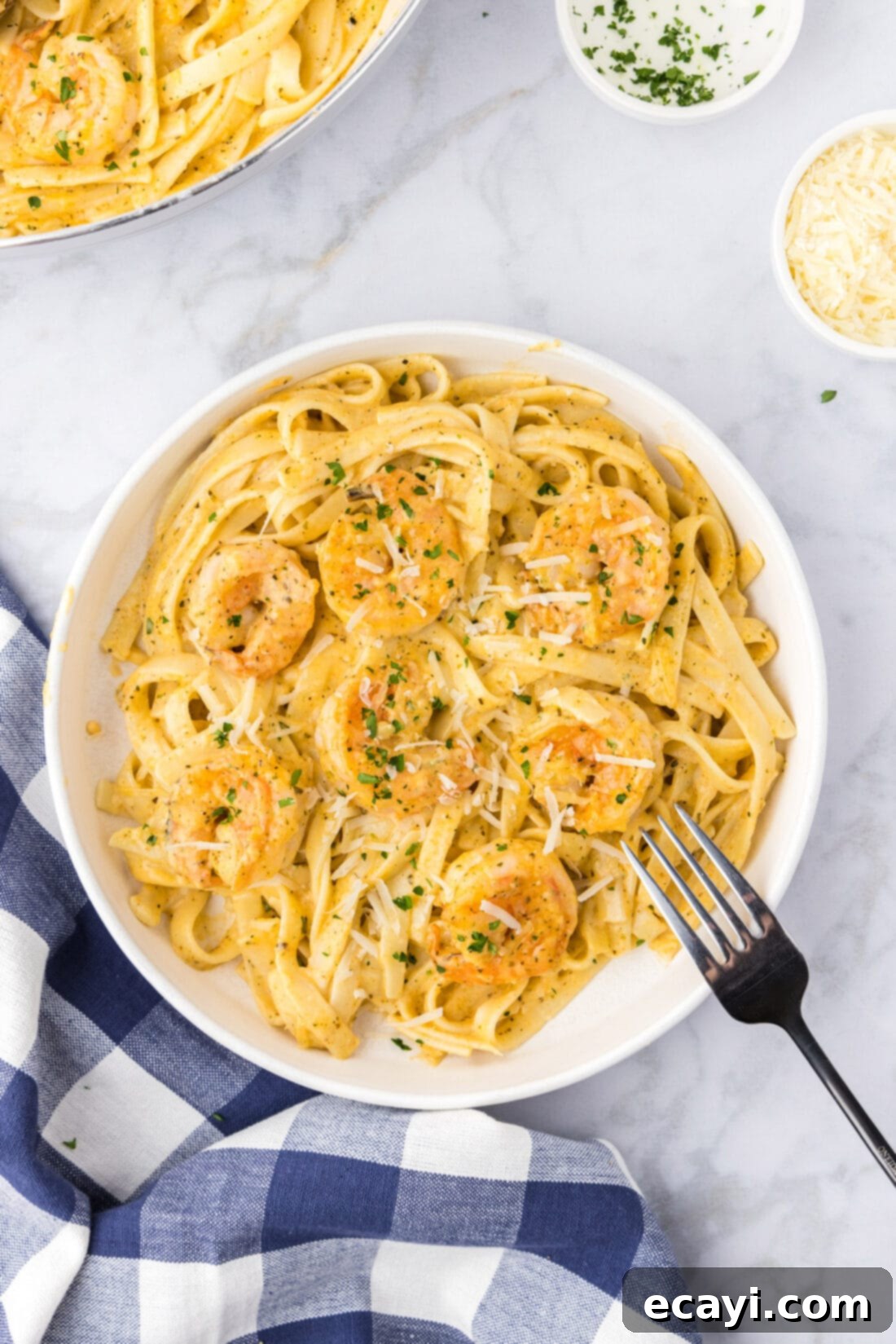 Shrimp Alfredo Bliss 3 A beautifully plated bowl of creamy shrimp alfredo pasta, garnished and ready to serve