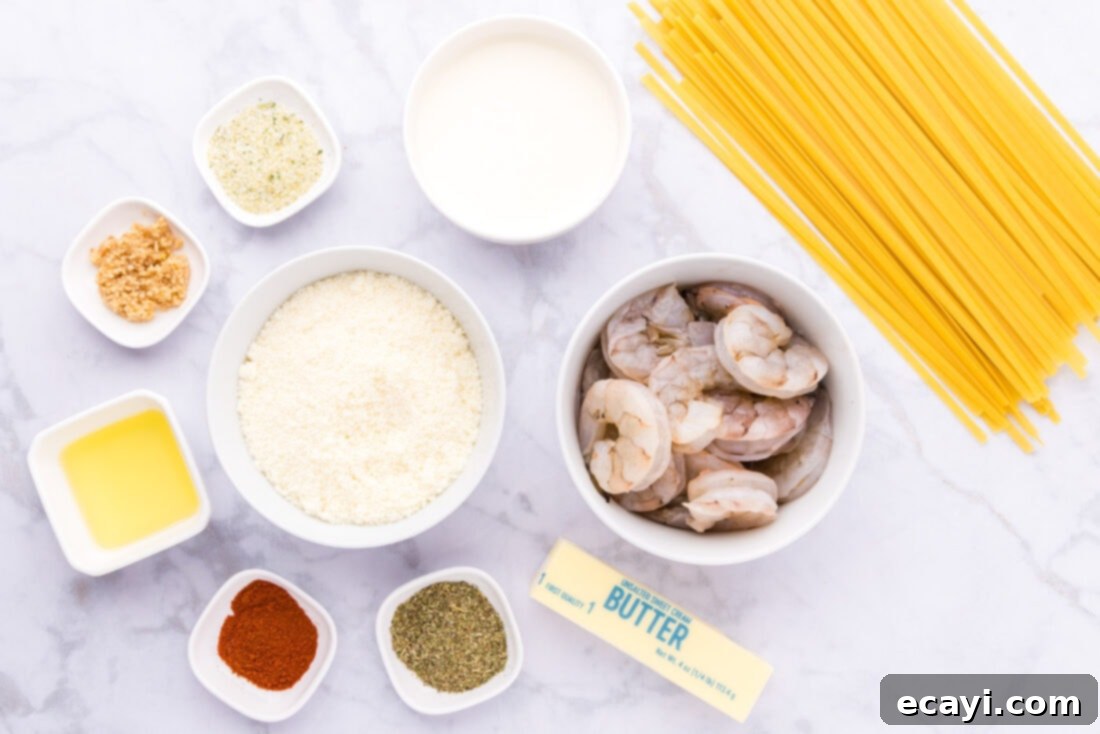 Shrimp Alfredo Bliss 4 All the fresh ingredients laid out on a counter, ready for making shrimp alfredo: shrimp, pasta, butter, cream, garlic, and spices