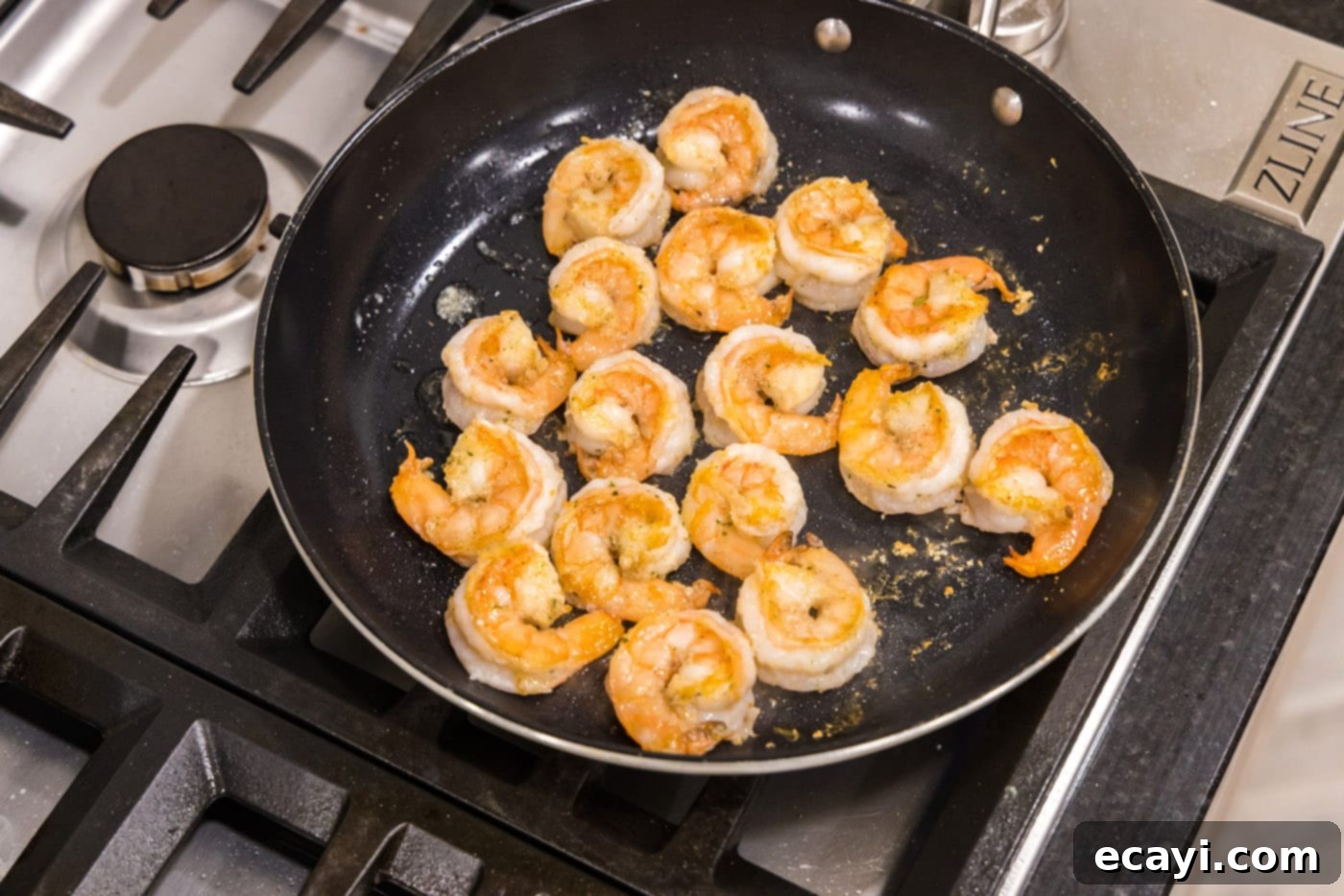 Shrimp Alfredo Bliss 7 Golden, perfectly sauteed shrimp resting in a skillet after cooking