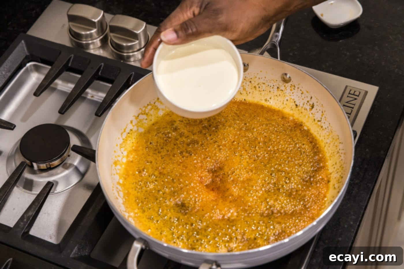 Shrimp Alfredo Bliss 9 Pouring rich heavy cream into the seasoned butter mixture for the alfredo sauce