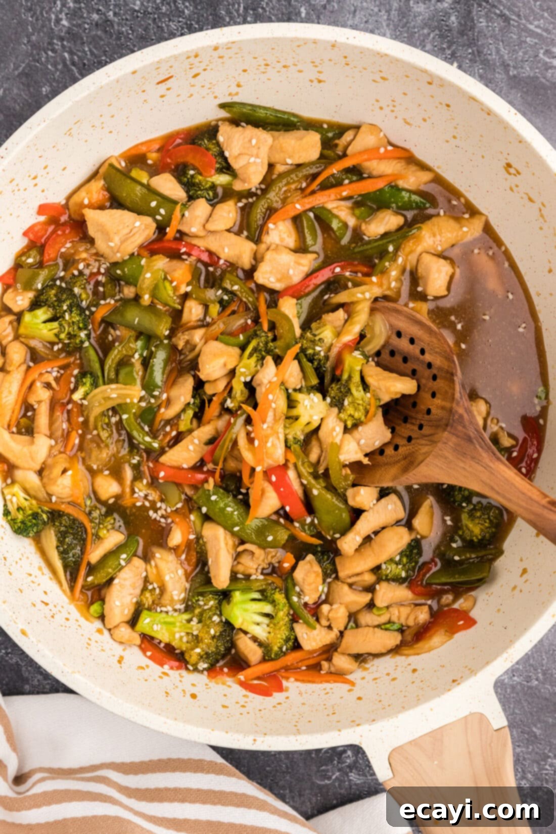 Sticky Honey Garlic Chicken Stir-Fry 2 Skillet of Honey Garlic Chicken Stir Fry with a spoon in it