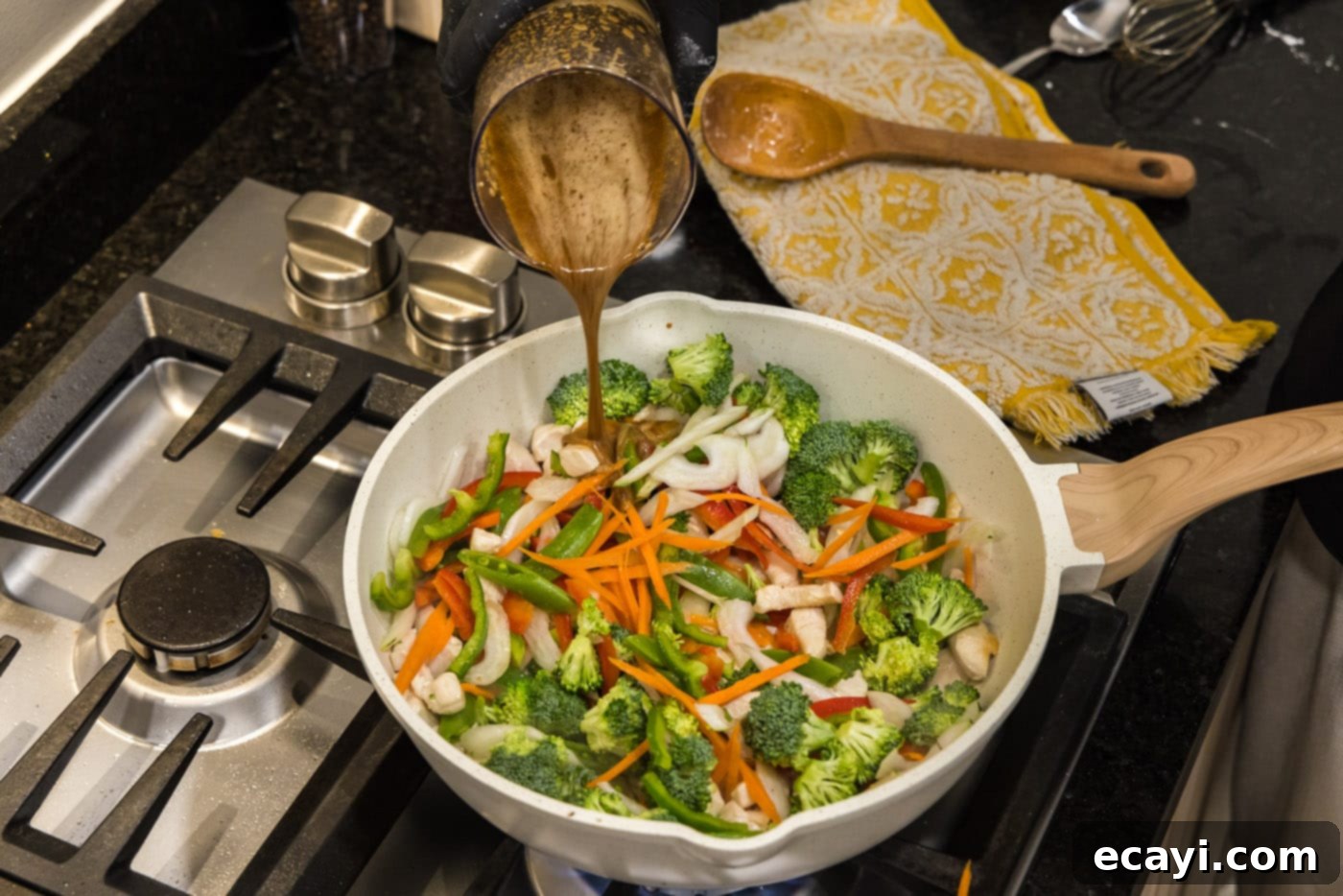 Sticky Honey Garlic Chicken Stir-Fry 11 pouring sauce into stir fry skillet