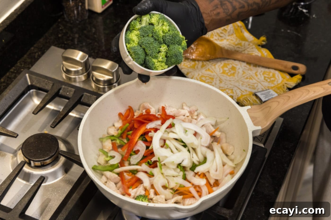 Sticky Honey Garlic Chicken Stir-Fry 8 adding broccoli to skillet with vegetables and chicken