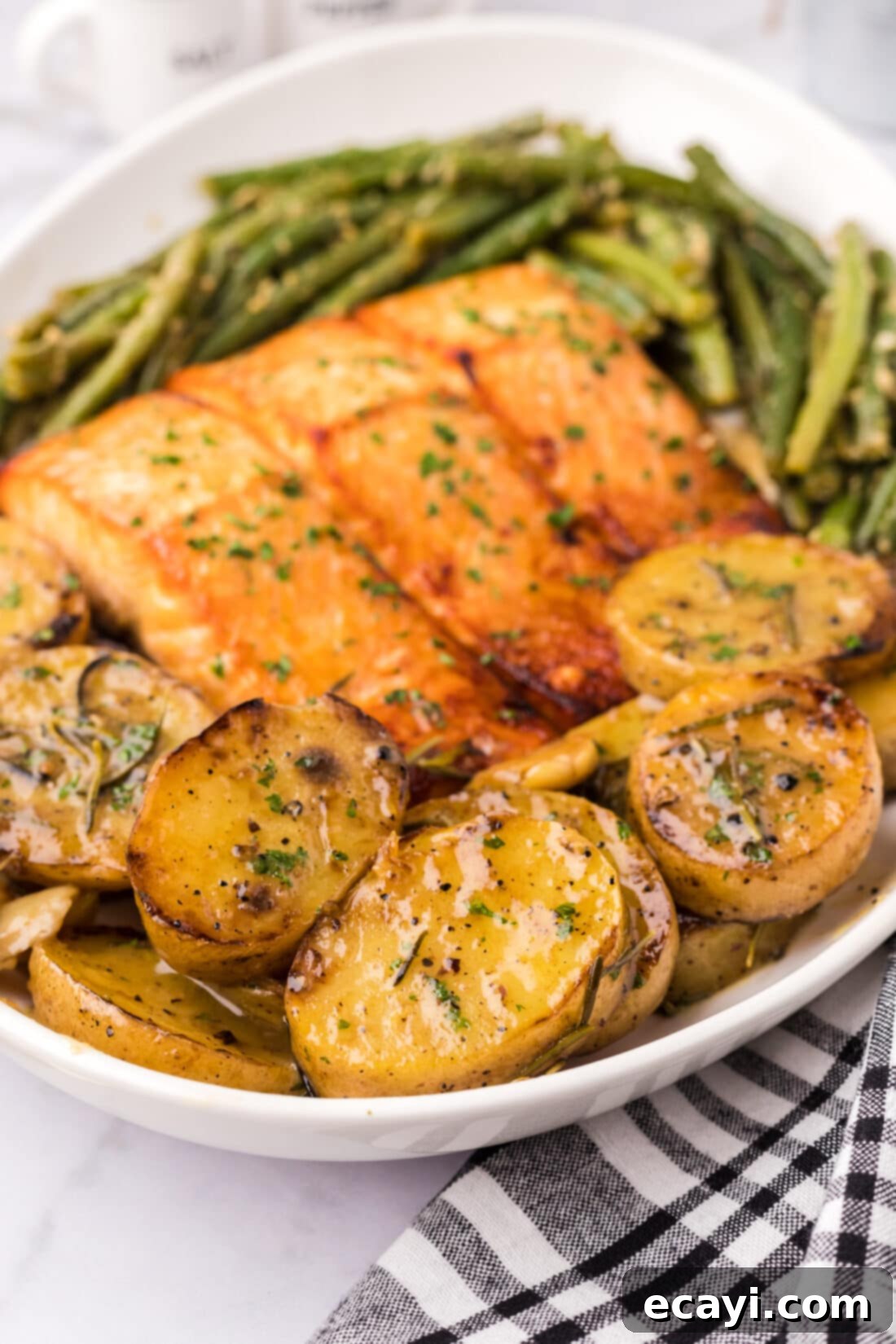 Ultra-Tender Melting Potatoes 3 Melting Potatoes on a platter with garlic green beans and brown sugar salmon