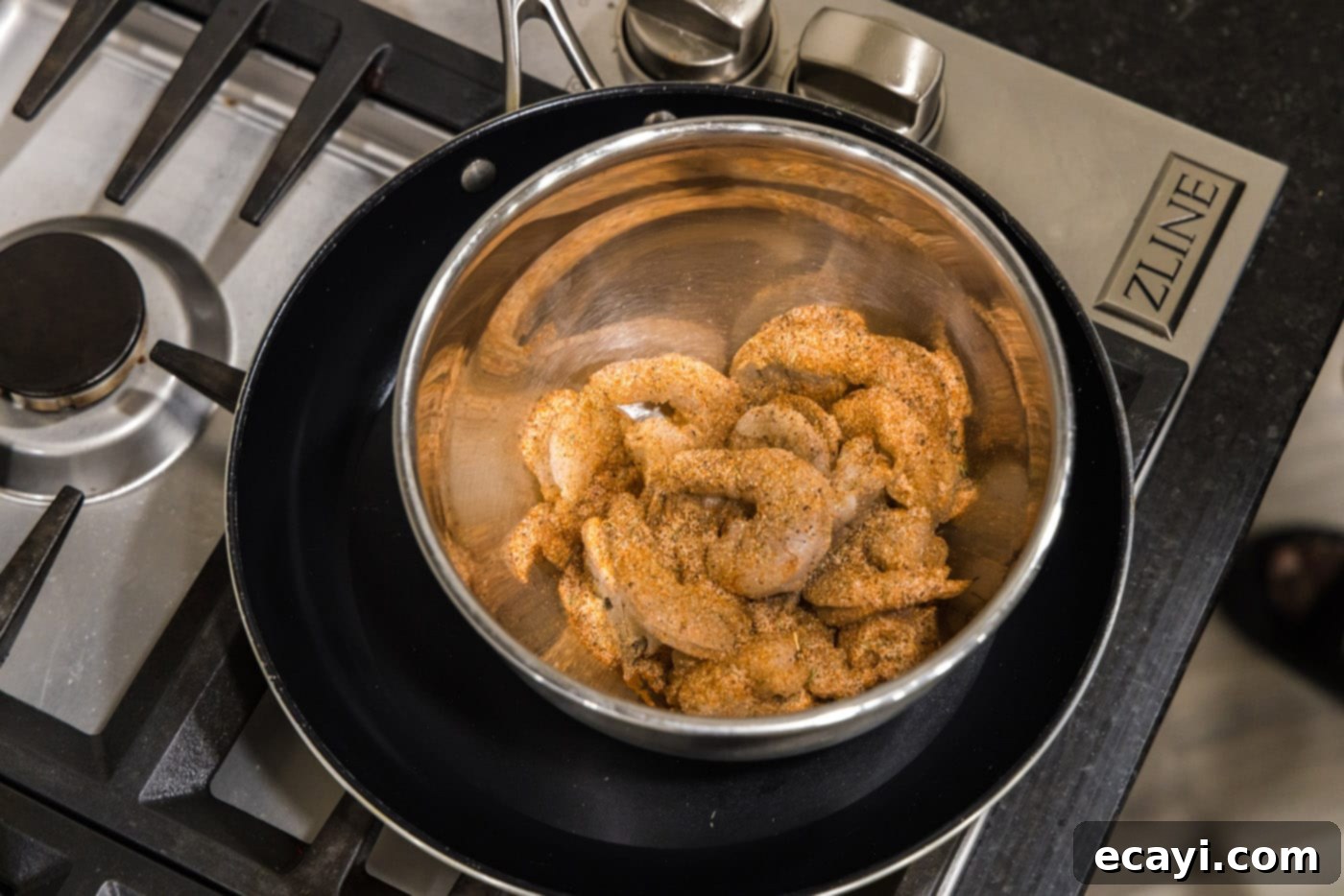 Fiery Cajun Prawns 5 cajun seasoned shrimp in a mixing bowl