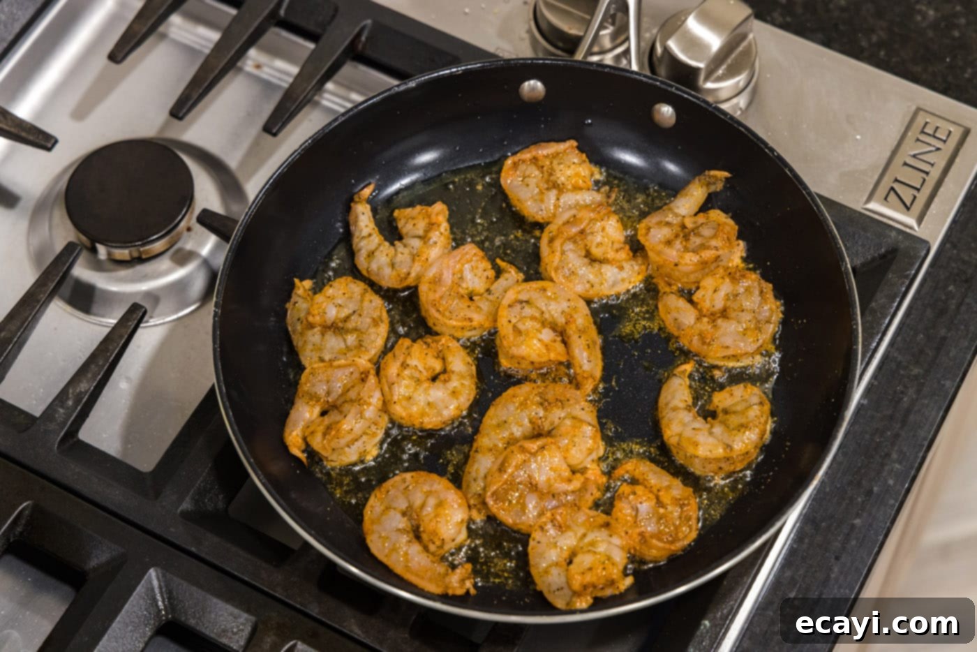 Fiery Cajun Prawns 6 cajun shrimp in a skillet with oil
