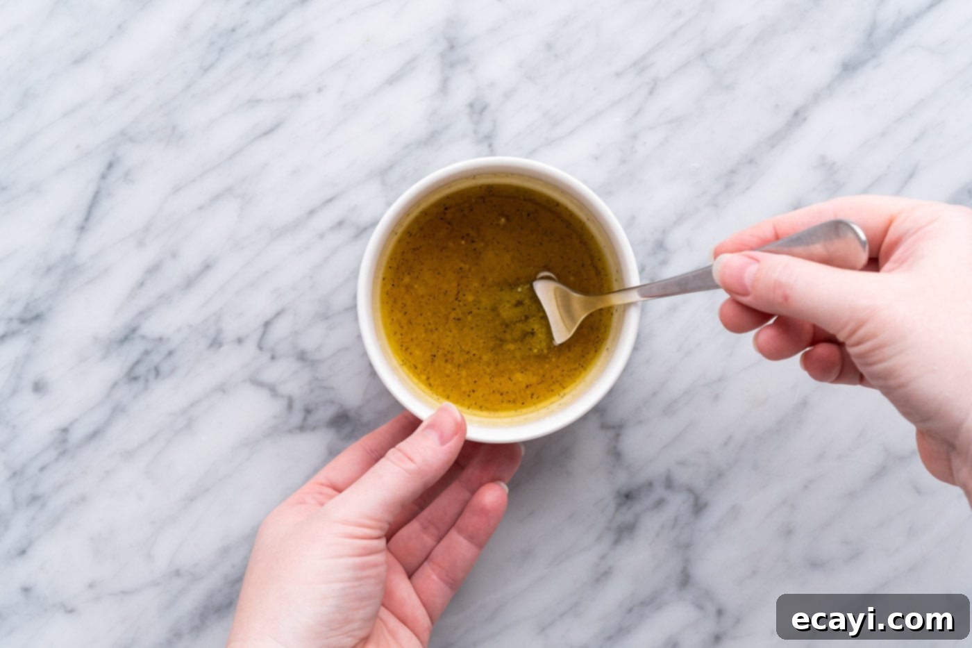 Zesty Lemon Vinaigrette 6 whisking lemon dressing in a small bowl with a fork