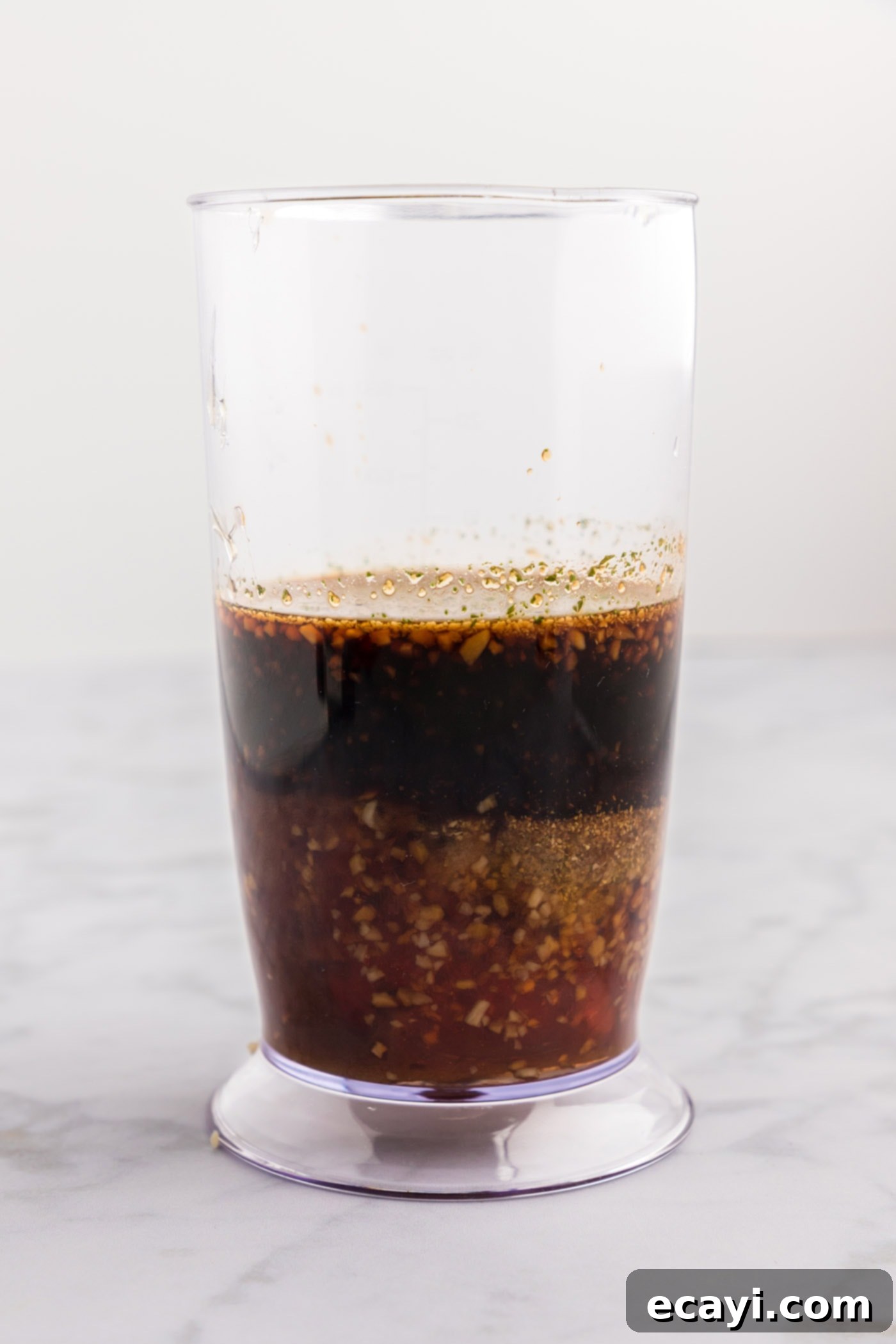 Delicious Honey Garlic Chicken Marinade 5 Soy sauce, vinegar, garlic, brown sugar, and honey are poured into an immersion blender cup, ready to be blended for the marinade.