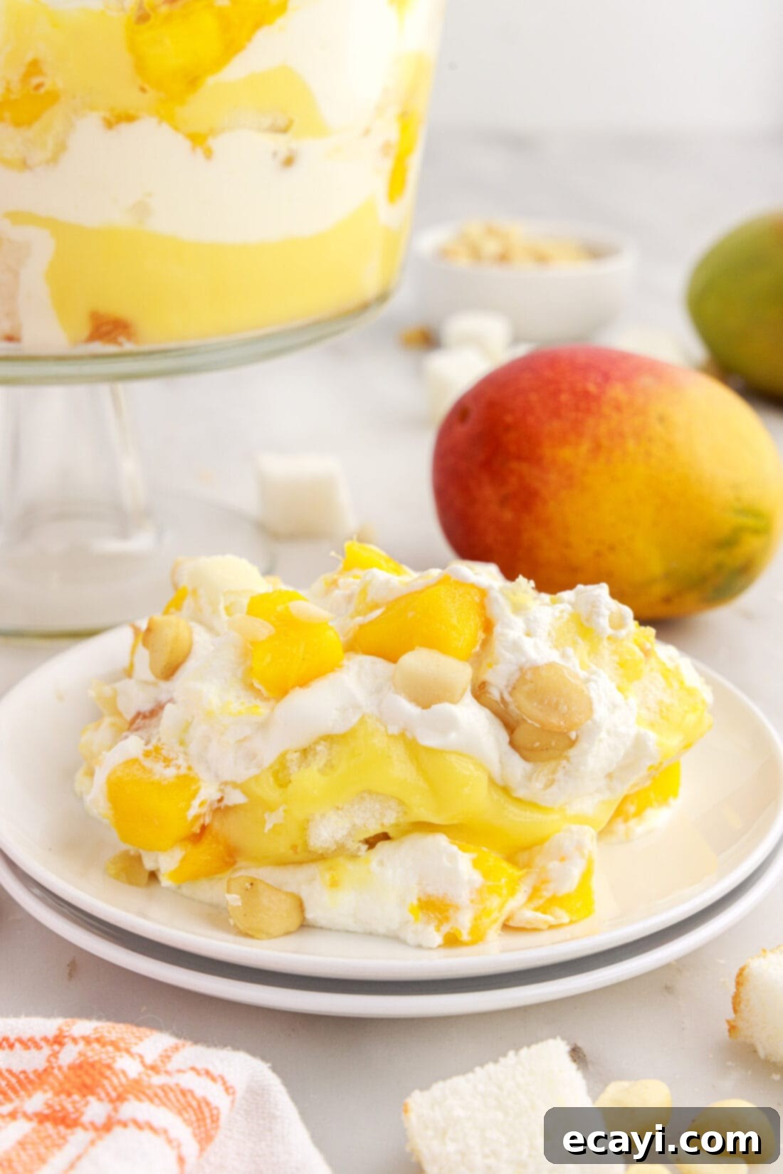 Golden Mango Indulgence 14 A single serving of Mango Trifle in a small bowl, garnished with white chocolate, ready to be enjoyed.