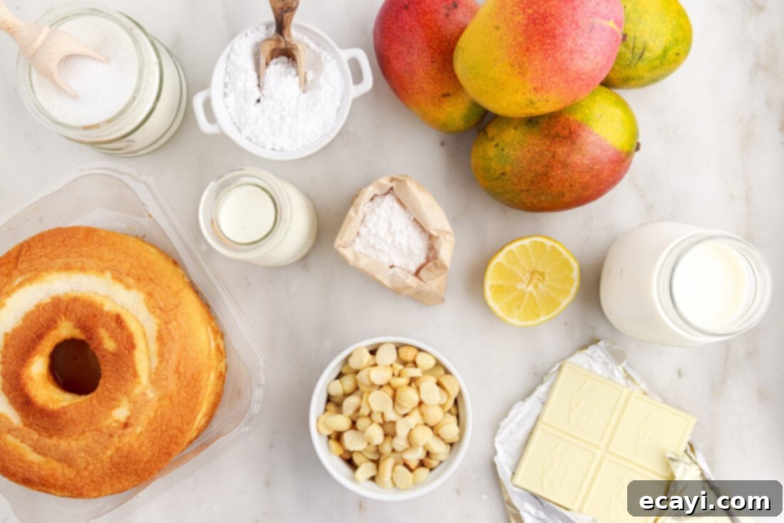 Golden Mango Indulgence 4 All the fresh ingredients laid out for making Mango Trifle, including angel food cake, fresh mangoes, pudding mix, heavy cream, and macadamia nuts.