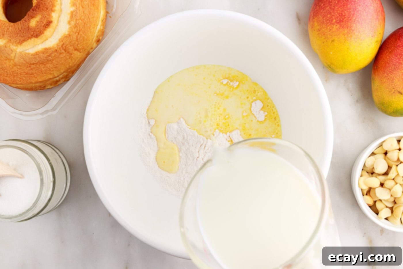 Golden Mango Indulgence 5 Adding cold milk to instant vanilla pudding mix in a bowl, preparing for whisking.