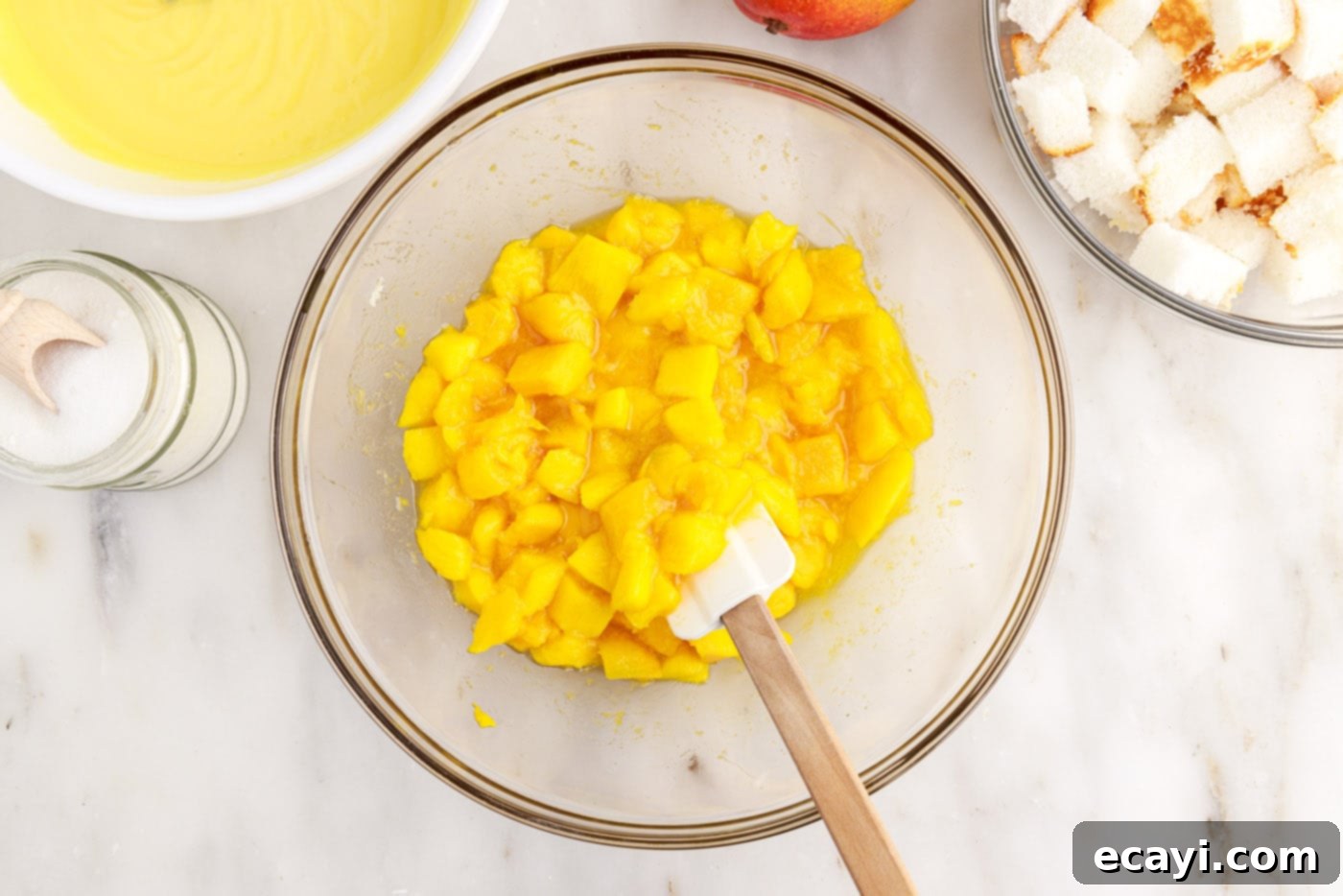 Golden Mango Indulgence 8 Macerated mangoes in a bowl, glistening with their own juices after being tossed with sugar and lemon juice.