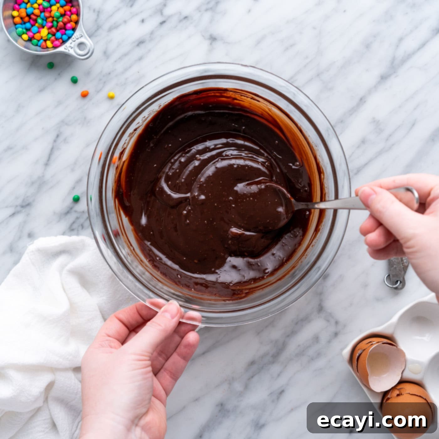 Dark Matter Delights 18 Silky smooth chocolate ganache topping in a bowl, ready to be spread over the brownies.