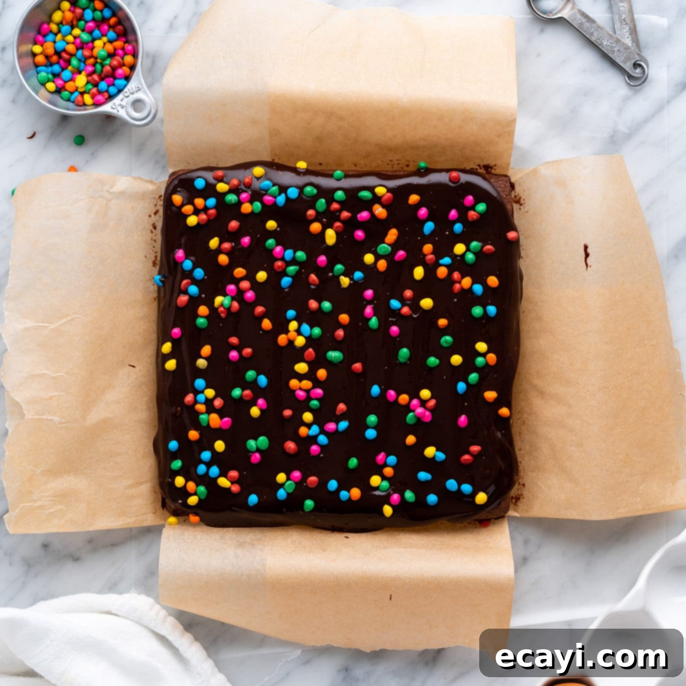 Dark Matter Delights 20 Cosmic brownie sprinkles generously scattered on top of the wet chocolate ganache.