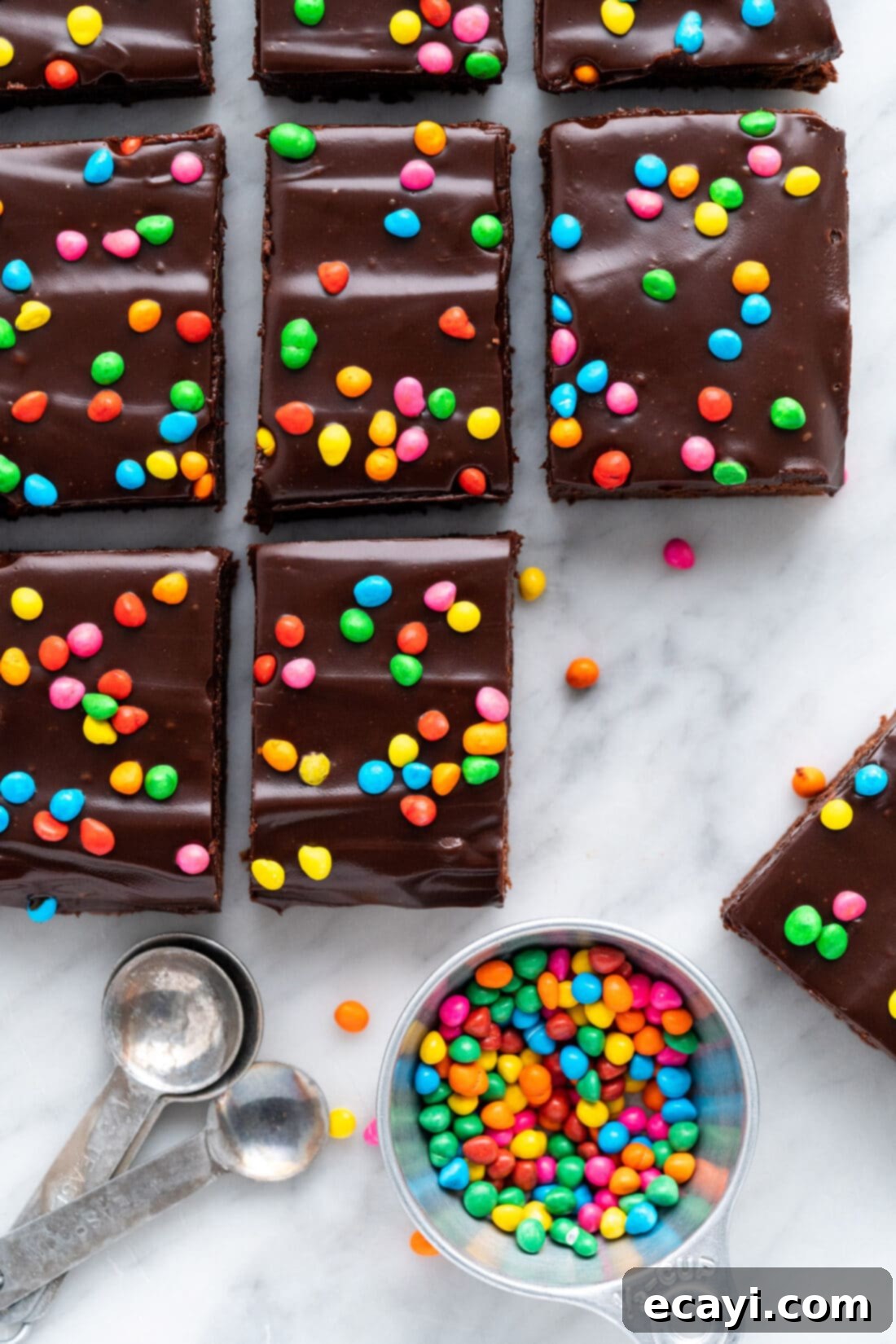 Dark Matter Delights 21 Cosmic Brownies cut into perfect squares, showcasing the fudgy texture and ganache topping with sprinkles.