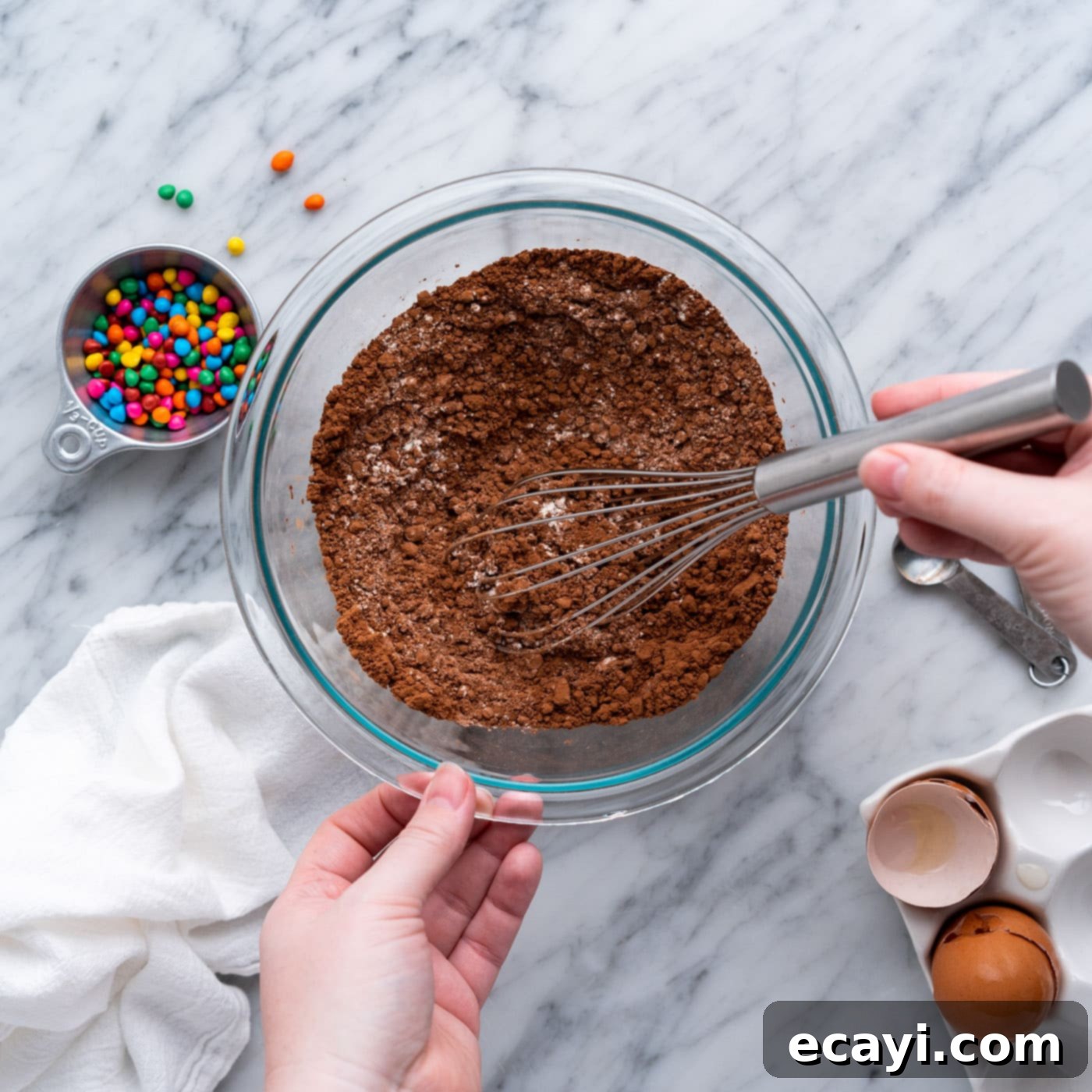 Dark Matter Delights 5 Whisking flour, cocoa powder, and salt in a bowl to ensure even distribution of dry ingredients for brownie batter.