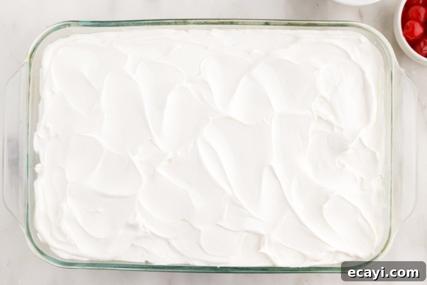 Billionaire Bliss Cake 13 Smooth layer of Cool Whip frosting elegantly topping the Millionaire's Cake.