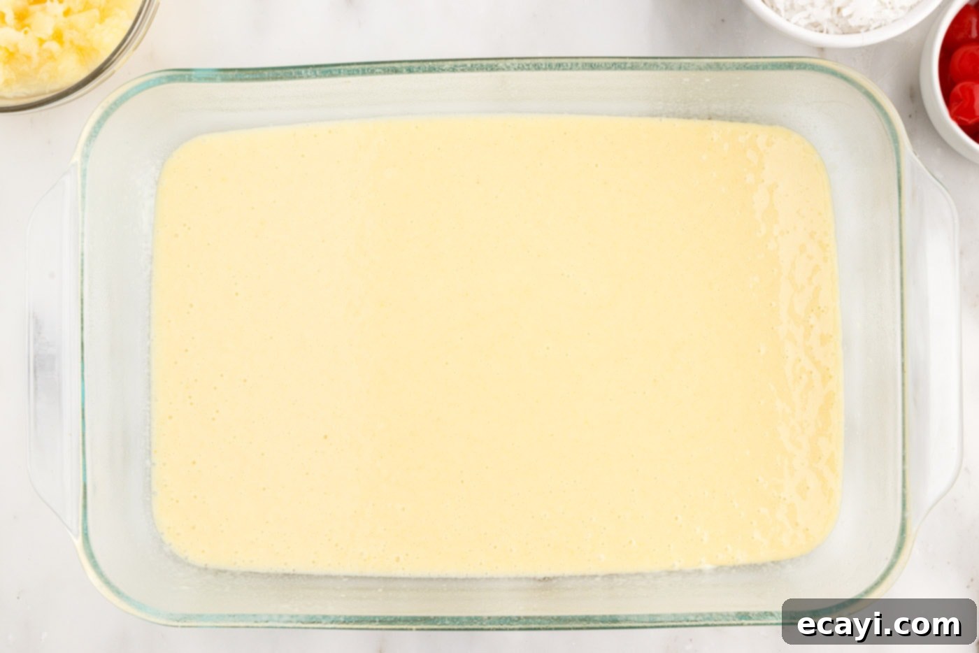 Billionaire Bliss Cake 7 Cake mix batter evenly spread in a baking dish, ready for the oven.