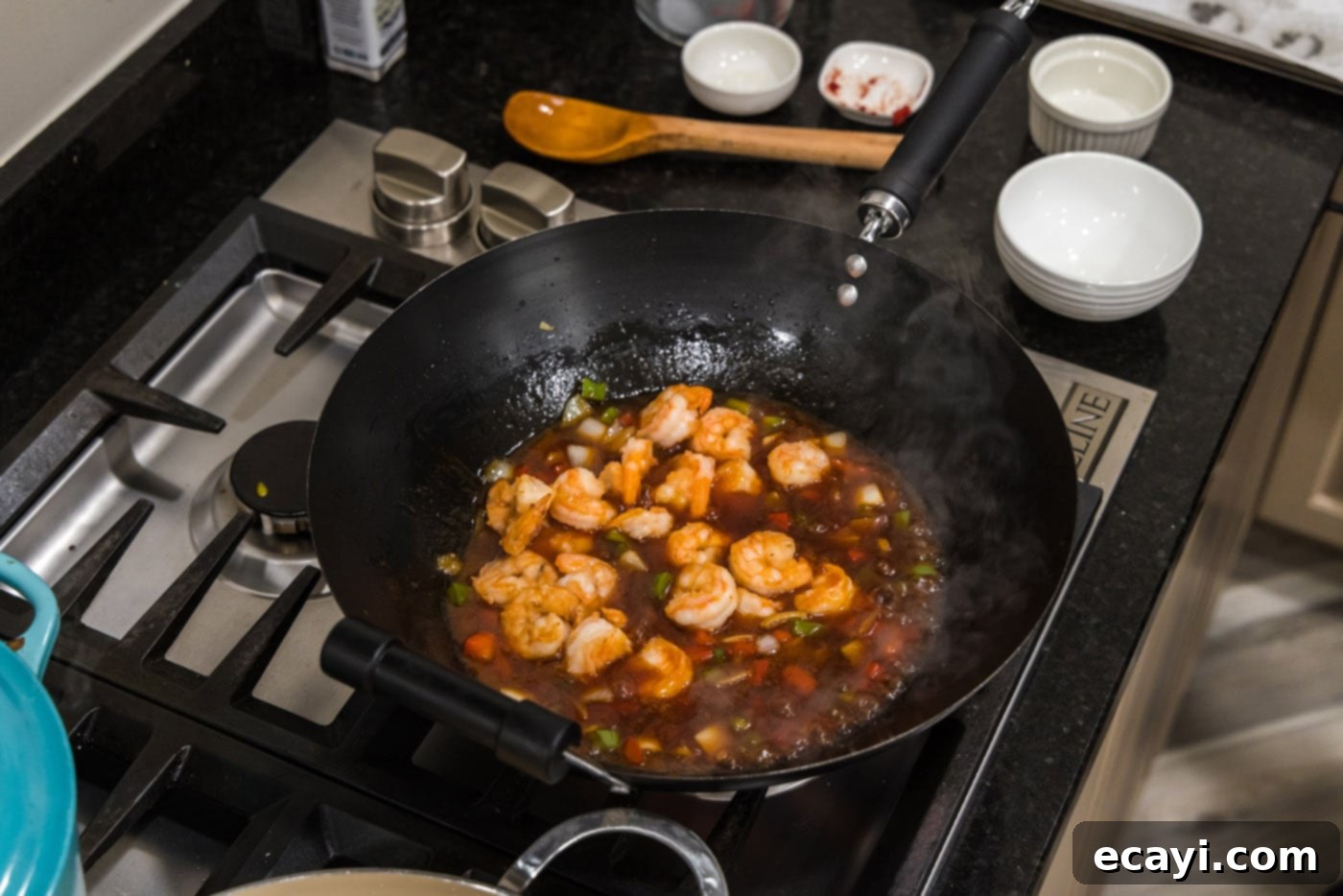 Tangy Prawn Delight 12 Shrimp coated in sweet and sour sauce in a wok.