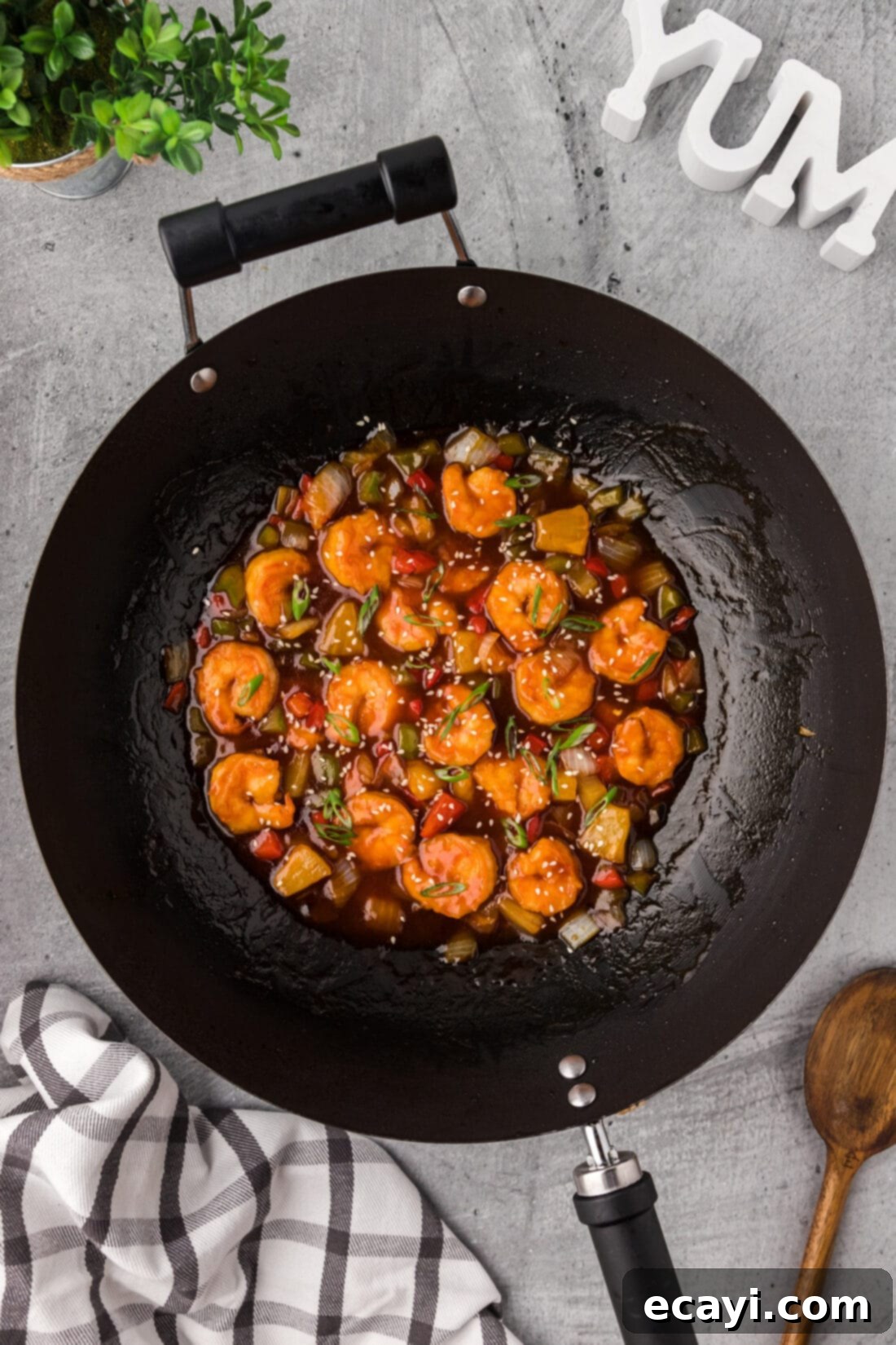 Tangy Prawn Delight 14 Sweet and Sour Shrimp sizzling in a wok, garnished and ready to serve.