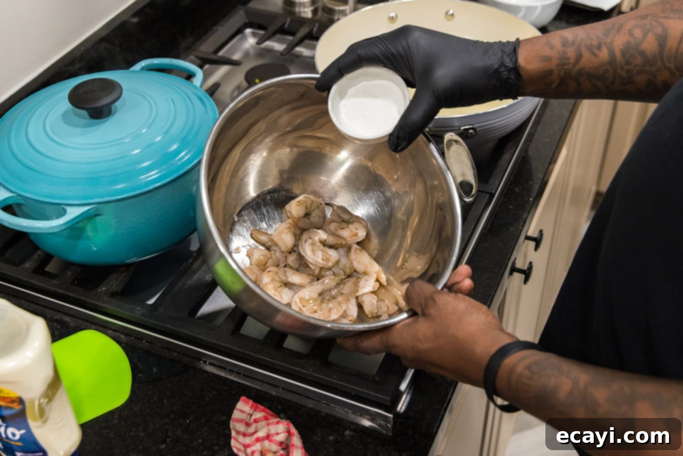 Tangy Prawn Delight 5 Tossing shrimp in cornstarch for a crispy coating.