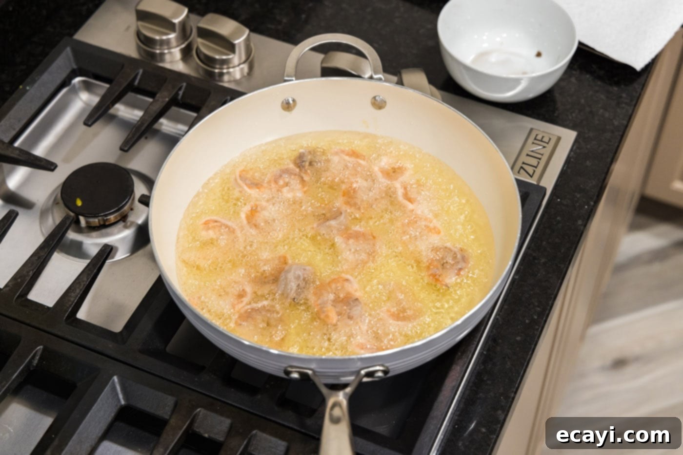 Tangy Prawn Delight 6 Deep frying shrimp in a skillet until golden and crispy.