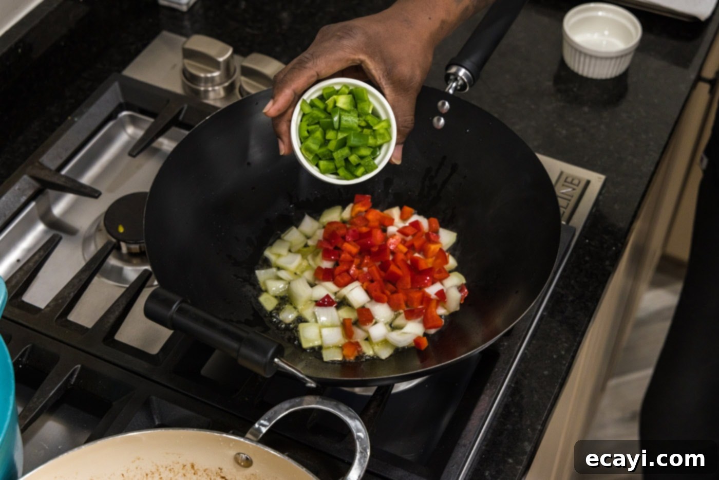Tangy Prawn Delight 7 Adding colorful bell peppers and onions to a hot wok.