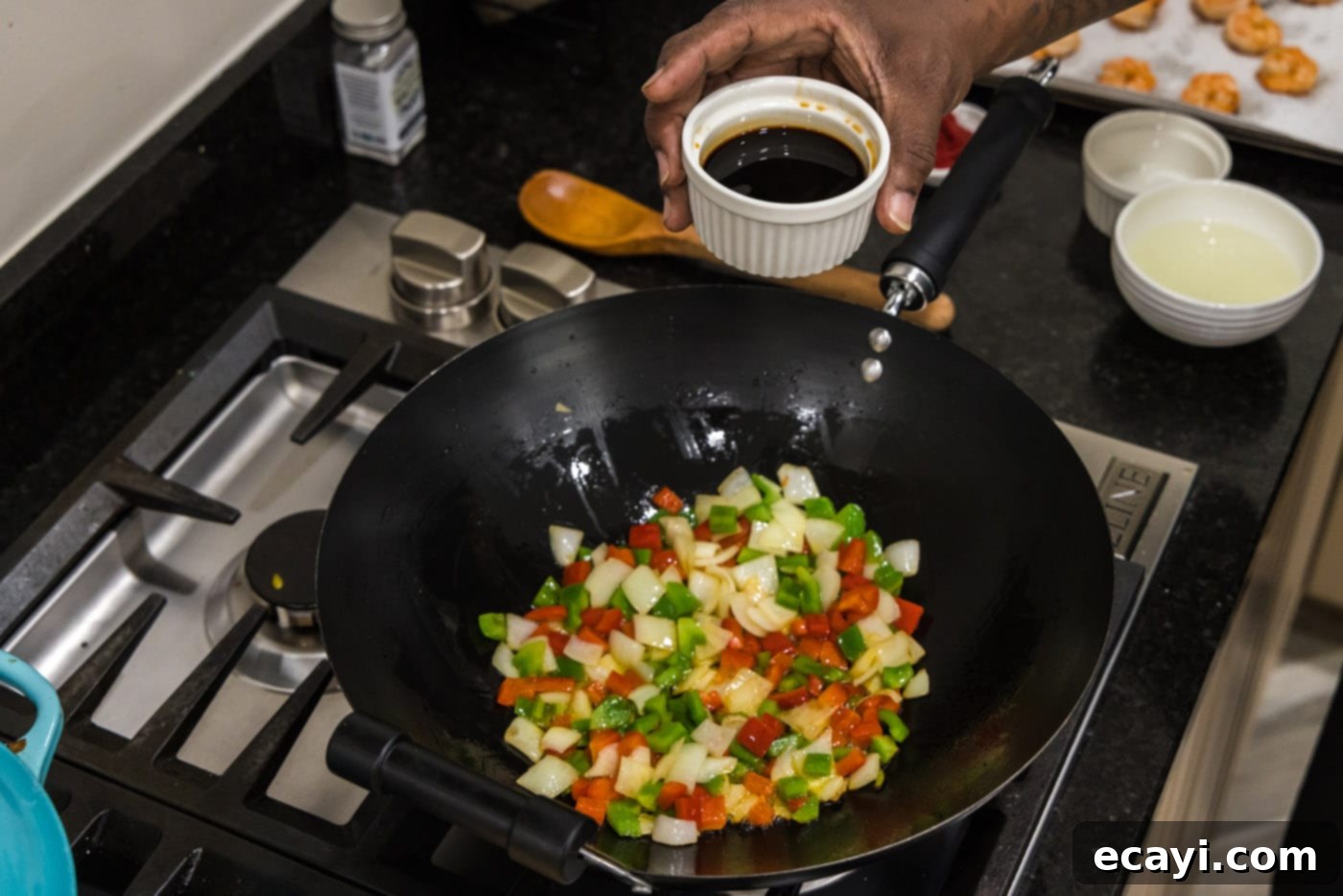 Tangy Prawn Delight 8 Adding soy sauce to the simmering vegetables in the skillet.