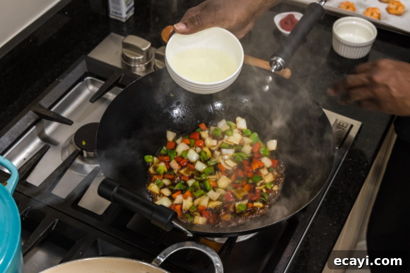 Tangy Prawn Delight 9 Pouring pineapple juice into the skillet with vegetables for the sauce.